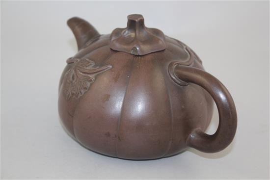 A Chinese Yixing melon-shaped teapot and cover, 19th / 20th century, length 18cm